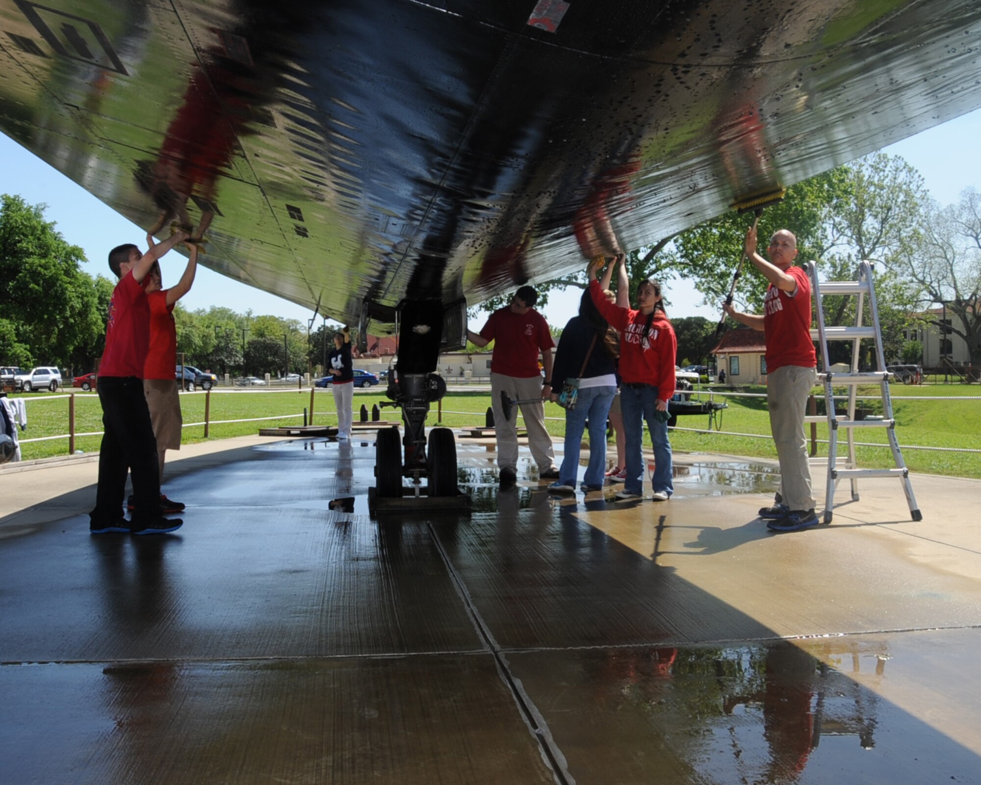 Students from the Haughton High School Junior Reserve Officer Training Corps clean an SR-71 Blackbird at the Barksdale Global Power Museum on Barksdale Air Force Base, La., April 24, 2013. The group adopted the aircraft as a community service project, and members ensure it stays clean and in presentation condition. Groups interested in adopting a plane can contact Amy Russell, museum director, at 456-2840. (U.S. Air Force photo/Senior Airman Sean Martin)