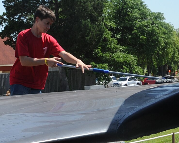 A student from the Haughton High School Junior Reserve Officer Training Corps washes the wing of an SR-71 Blackbird at the Barksdale Global Power Museum on Barksdale Air Force Base, La., April 24, 2013. Haughton is the first JROTC group to adopt an aircraft at the museum. Groups interested in adopting a plane can contact Amy Russell, museum director, at 456-2840. (U.S. Air Force photo/Senior Airman Sean Martin)