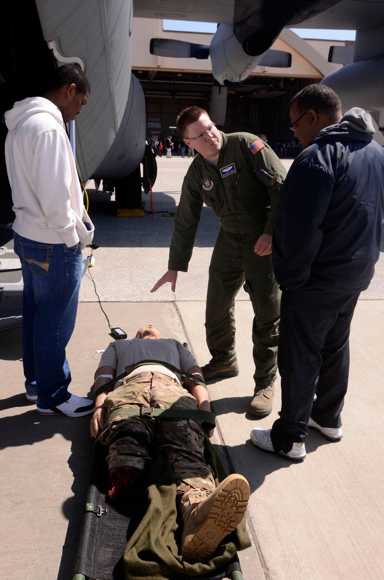 Tech Sgt. Joshua C. Albertin, Medical Technician from the 94th Aeromedical Squadron explains the function of the high-fidelity patient simulator, or IStan, and mission of the Aeromedical teams  to students and family members attending the 2013 Georgia Congressional Delegation Academy Day held at Dobbins Air Reserve Base, Ga., April 20. (U.S. Air Force photo/Don Peek)