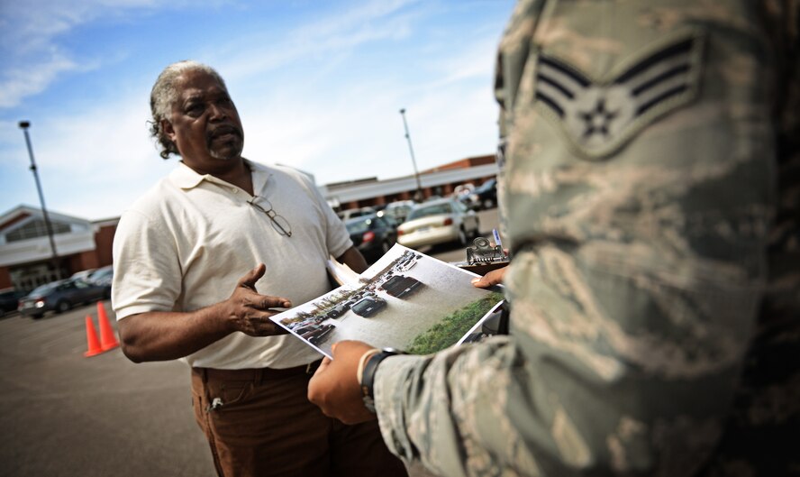 Airman 1st Class Jacy Carpenter, 375th Air Mobility Wing legal assistant, assists a government employee on Scott Air Force Base with a damage to personal property claim April 22, 2013, following severe weather which caused flooding in many areas on base. Due to the massive flooding on base the legal office was able to have the area declared as an "unusual event" allowing people to file claims with the Air Force Claims Service Center.(U.S. Air Force photo/ Staff Sgt. Ryan Crane)