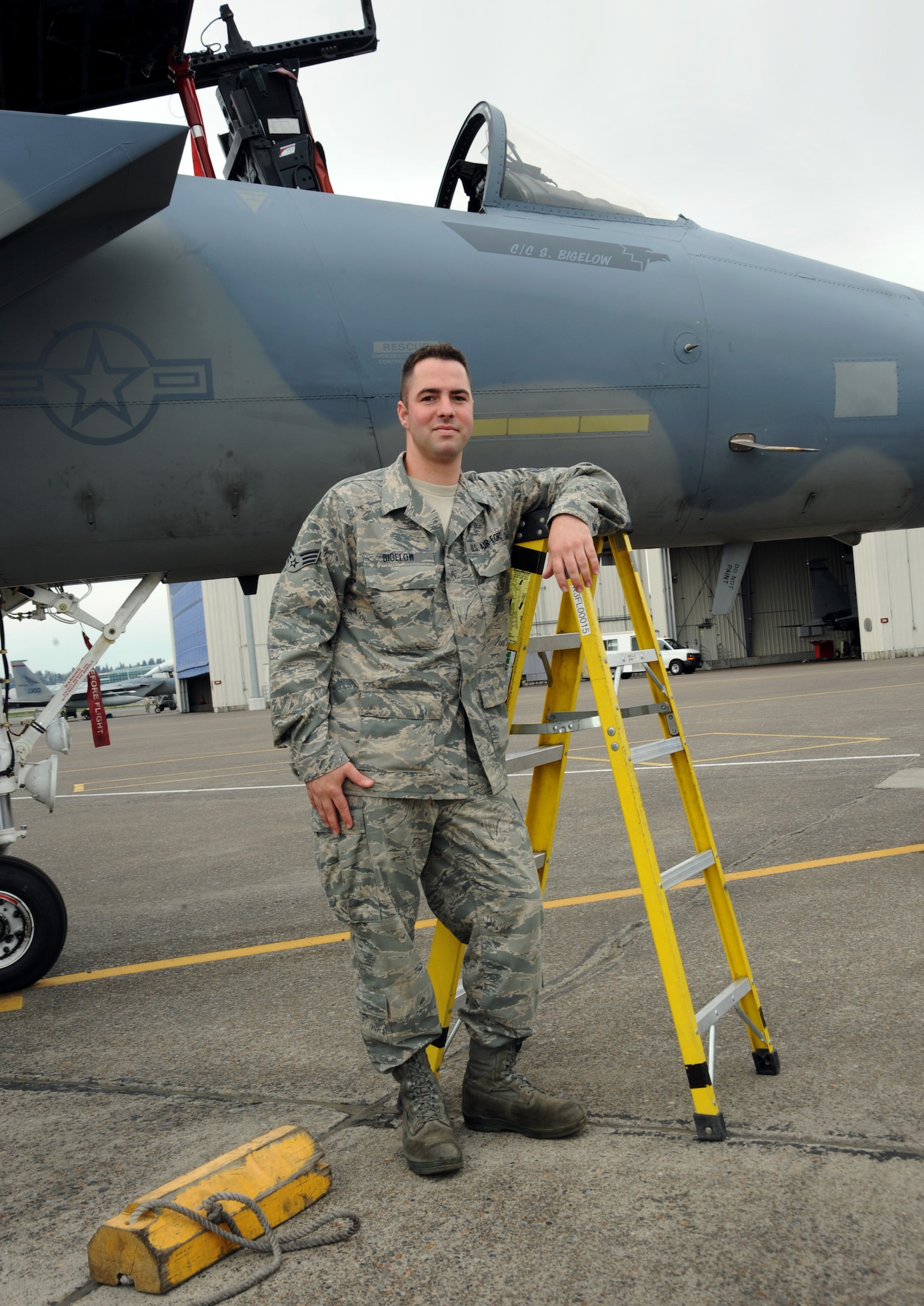 142nd Fighter Wing Senior Airman Sean Bigelow stands next to his F-15 Eagle that he maintains with the unit at the Portland, Air National Guard Base, Portland, Ore., April 4, 2013.  Sean Bigelow has been with unit for almost six years working as a crew chief. (Air National Guard photo by Tech. Sgt. John Hughel, 142nd Fighter Wing Public Affairs Office)