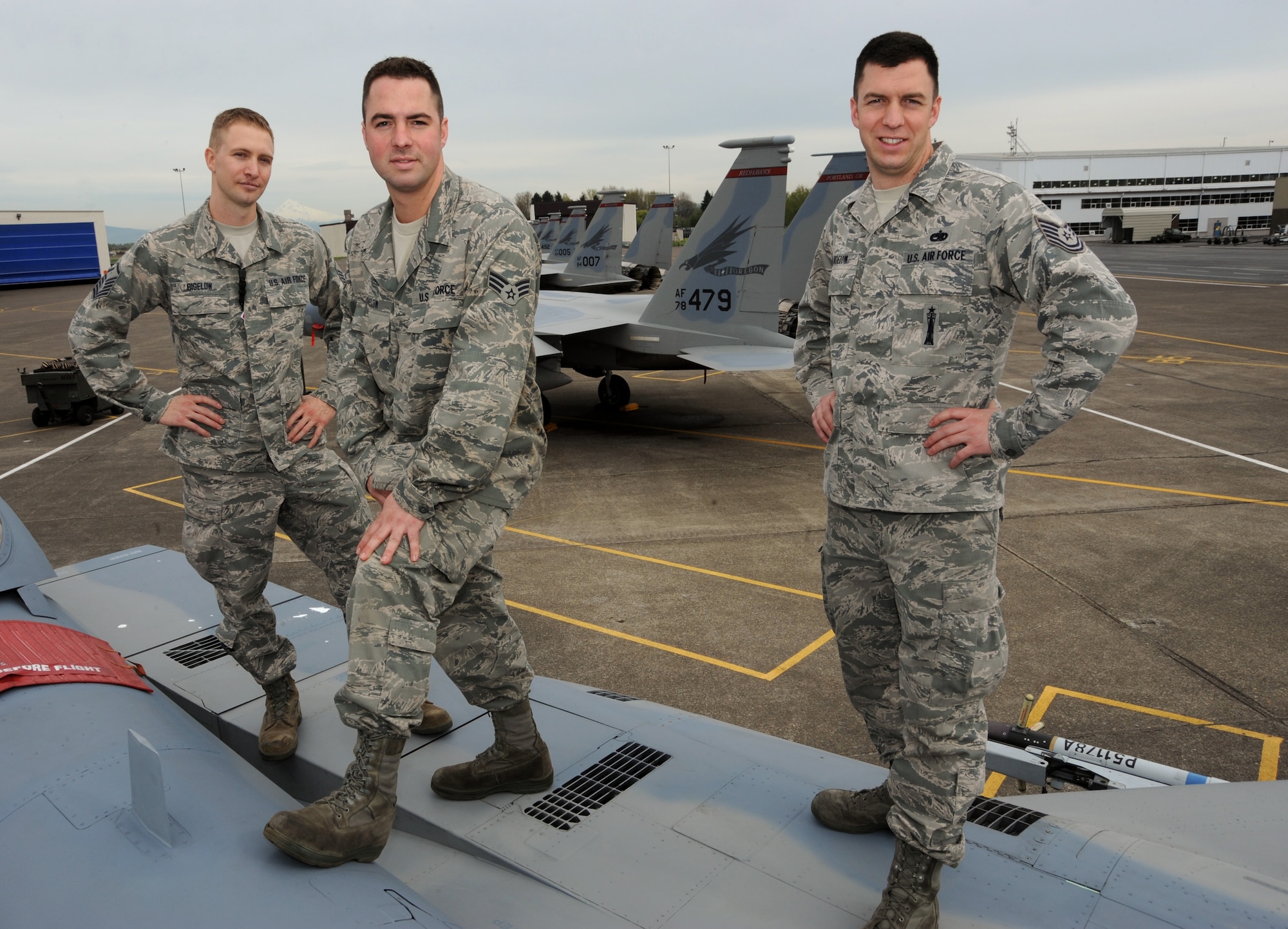 The three Bigelow bothers (left to right), Master Sgt. Ricky Bigelow, Senior Airman Sean Bigelow and Tech. Sgt. Jordan Bigelow stand together on an F-15 Eagle at the Portland Air National Guard Base, Portland, Ore., April 3, 2013.  All three brothers are members of the 142nd Fighter Wing and perform various maintenance trades on the supersonic air-to-air fighter jet. (Air National Guard photo by Tech. Sgt. John Hughel, 142nd Fighter Wing Public Affairs Office)