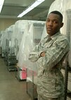 Airman 1st Class Dominic Robertson, 319th Communications Squadron base records management, stands alongside hundreds of boxed records in the base staging room. Robertson was named the Grand Forks Air Force Base Warrior of the Week for fourth week of April 2013. (U.S. Air Force photo/Airman 1st Class Zachiah Roberson)