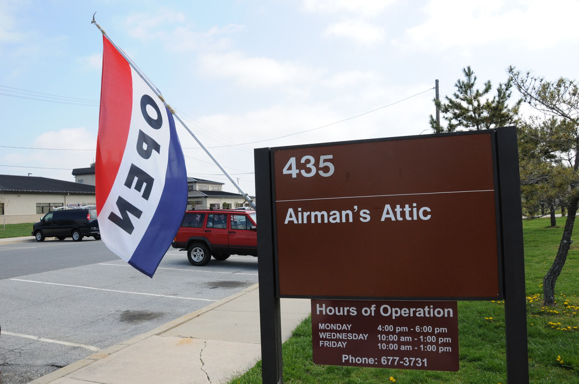 A flag is posted outside the Airman's Attic during hours of operation April 24, 2013, at Dover Air Force Base, Del. The Airman's Attic is a volunteer-based organization set up to provide Dover Airmen, E-5 and below, and their families, with new and used donated items at no cost. (U.S. Air Force photo/Senior Airman Joe Yanik)
