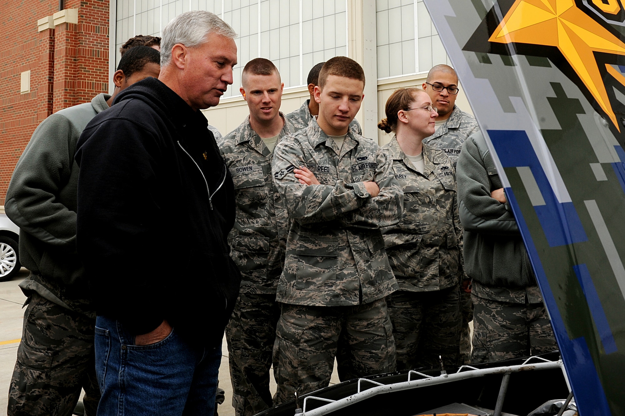 U.S. Air Force Airmen from the 1st Maintenance Squadron view a NASCAR competition vehicle at Langley Air Force Base, Va., April 24, 2013. Blake Koch, Nationwide driver of the #24 SupportMilitary.org NASCAR vehicle, visited Langley prior to competing in the Spring Cup Series race in Richmond, Va. (U.S. Air Force photo by Airman 1st Class Kimberly Nagle/Released)