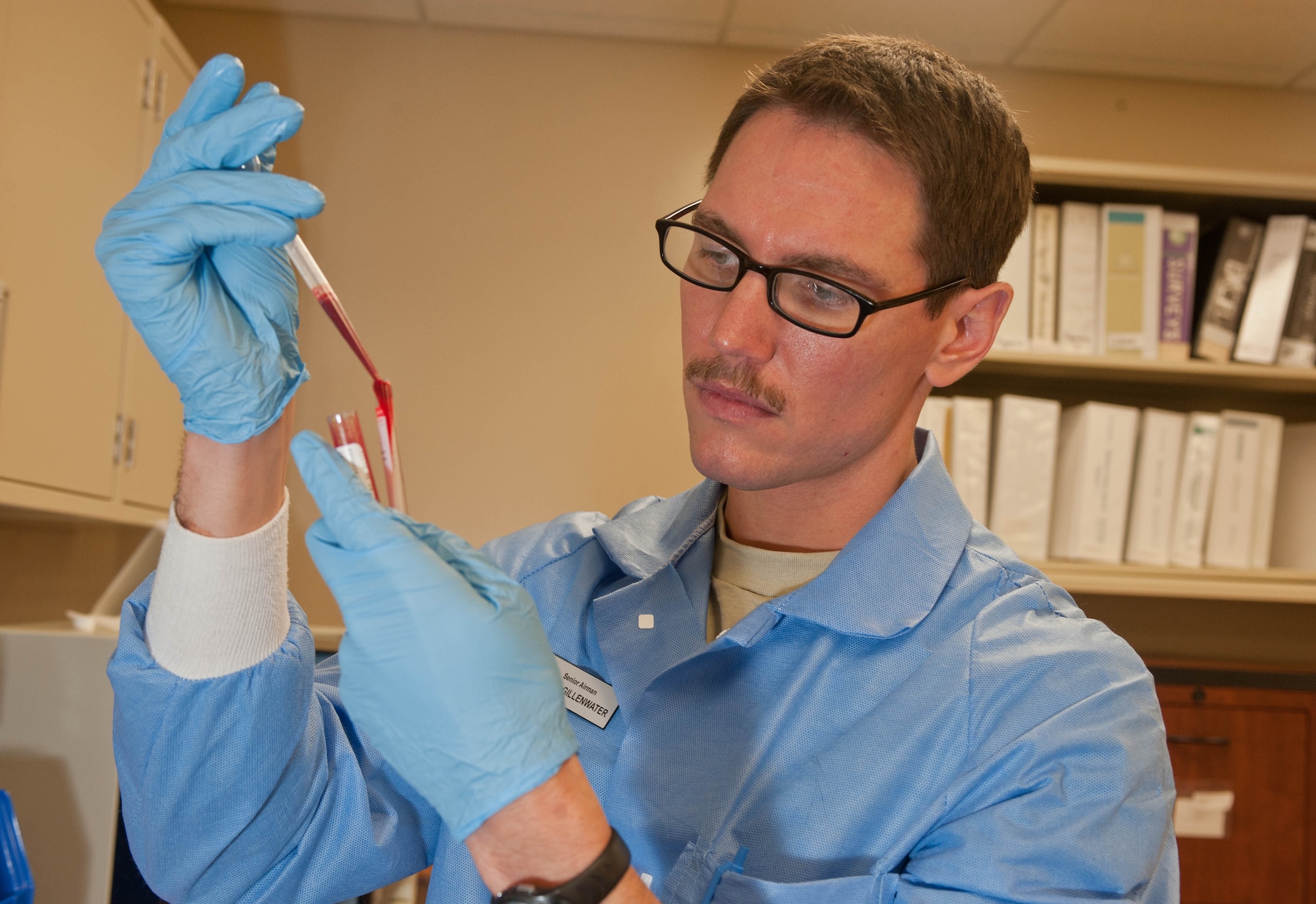 Senior Airman Lance Gillenwater, 28th Medical Support Squadron medical laboratory technician, transfers blood to a chemical analyzer in the clinical laboratory at Ellsworth Air Force Base, S.D., April 19, 2013. The specialized medical instrument examines blood samples for various biological elements such as cholesterol, electrolytes and calcium. (U.S. Air Force photo by Airman 1st Class Zachary Hada/Released)