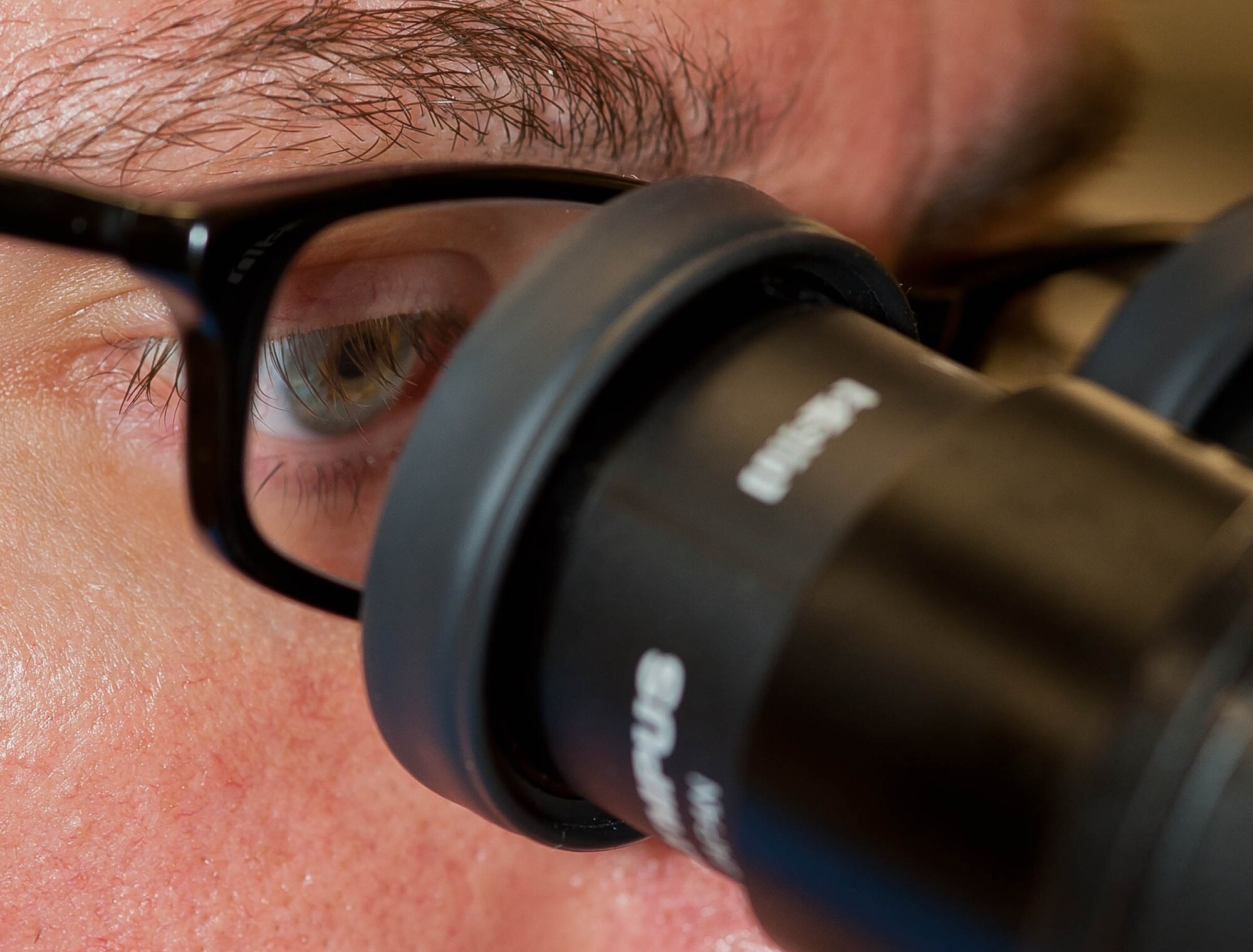 Senior Airman Lance Gillenwater, 28th Medical Support Squadron medical laboratory technician, observes blood under a microscope in the clinical laboratory at Ellsworth Air Force Base, S.D., April 19, 2013. Lab technicians are responsible for analyzing specimens from patients to assist physicians as they assess the health of Airmen and their families on Ellsworth. (U.S. Air Force photo by Airman 1st Class Zachary Hada/Released)