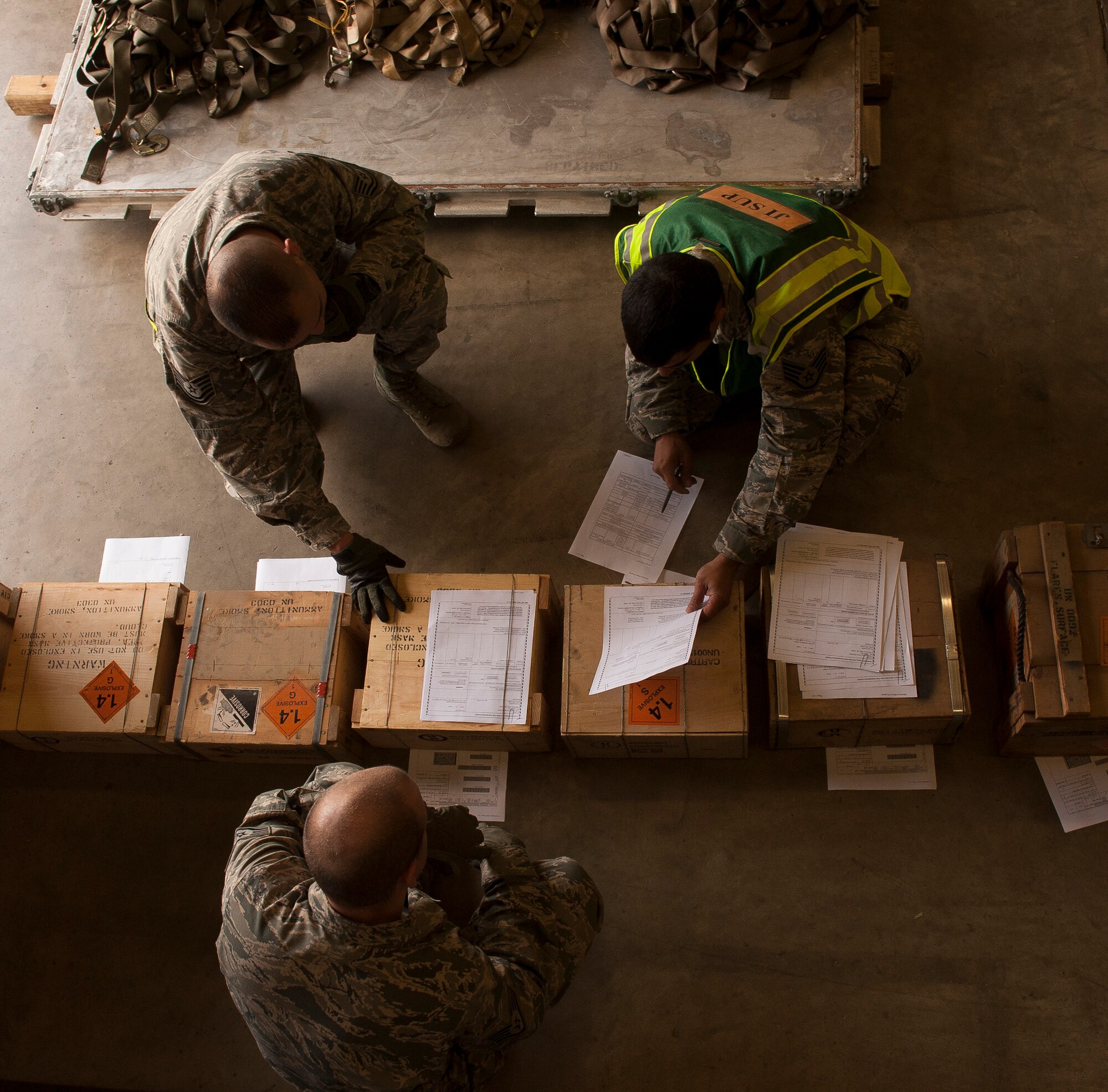 Staff Sgt. Richard DeRosa, a 19th Logistics Readiness Squadron joint inspector supervisor, reviews paper work with Tech. Sgt. Juan Chavez and Staff Sgt. Charles Hardy, 19th Security Forces Squadron unit deployment managers, during the ROCKEX April 23, 2013, at Little Rock Air Force Base, Ark. The 19th Airlift Wing conducted the exercise to test their world-wide deployment capabilities. (U.S. Air Force photo by Staff Sgt. Russ Scalf)