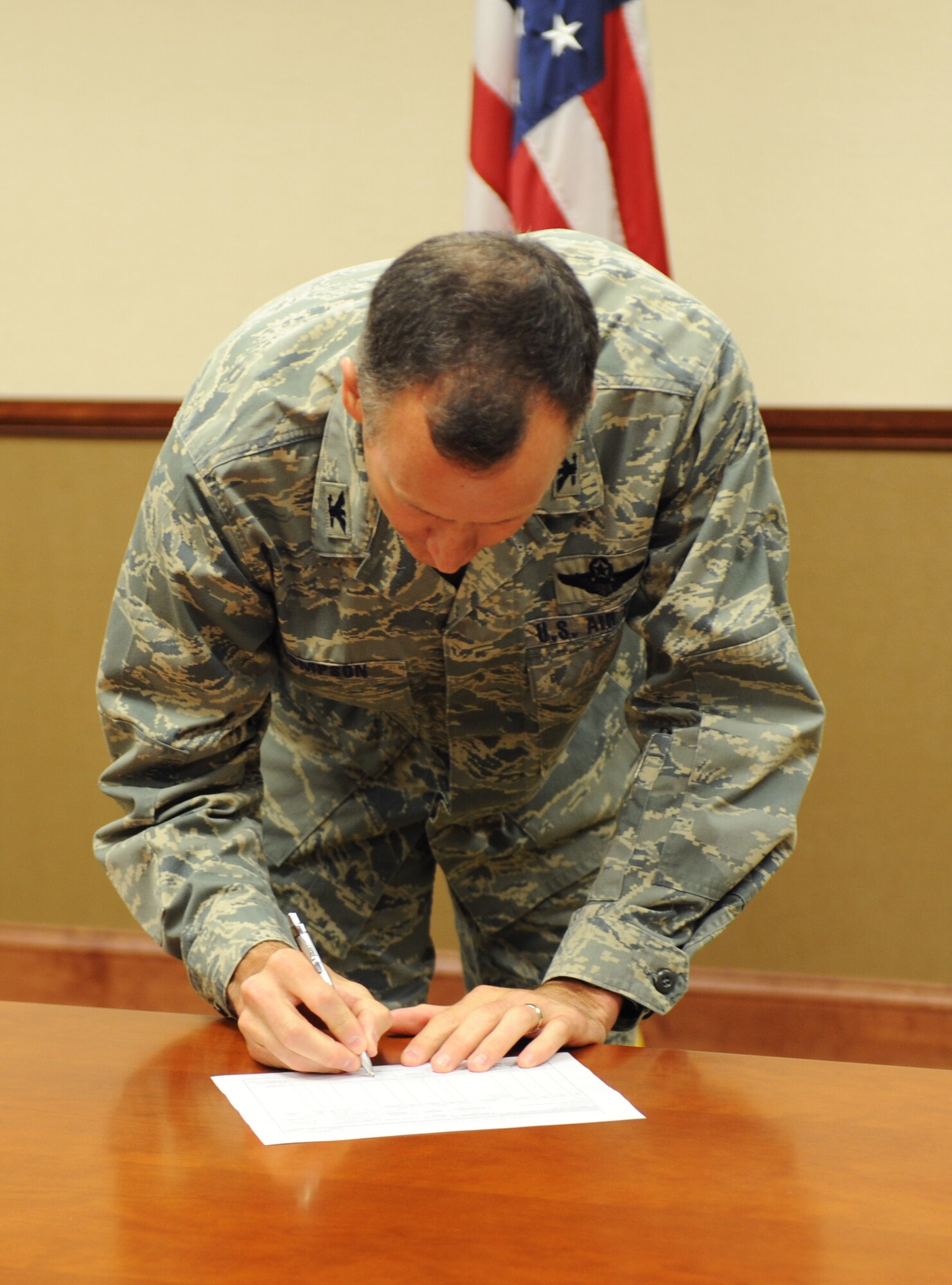 U.S. Air Force Col. Billy Thompson, 23d Wing commander, signs a Transfer and Acceptance of DoD Real Property document April 22, 2013, at Moody Air Force Base, Ga. The signing solidified the transfer of 24.56 acres of land over to Moody. (U.S. Air Force photo by Staff Sgt. Melissa K. Mekpongsatorn/Released)
