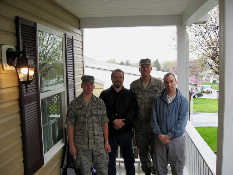 (left to right) Staff Sgt. Michael Wilson, Mr. Tim Pickard, Senior Master Sgt. Kevlin Mauk and Staff Sgt. Brian Henson stand on the front porch of the Dayton Habitat for Humanitarian home they helped build. (U.S. Air Force photo by Ted Theopolos)