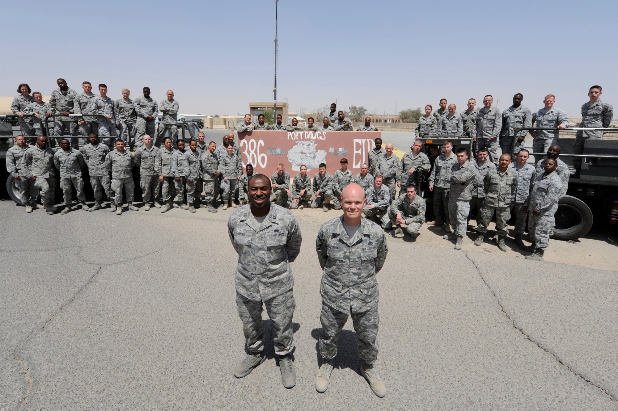 Senior Master Sgt. Paul Carter, 386th Expeditionary Logistics Readiness Squadron, Port Superintendent (right) with the “Port Dawgs” at the 386th Air Expeditionary Wing, Southwest Asia April 15, 2013. Carter is one of 48 Airmen from Dobbins Air Reserve Base, Ga. deployed to ‘The Rock’ where they make up roughly 60 percent of the 85 member port team. (U.S. Air Force photo by Staff Sgt. Austin Knox/Released)