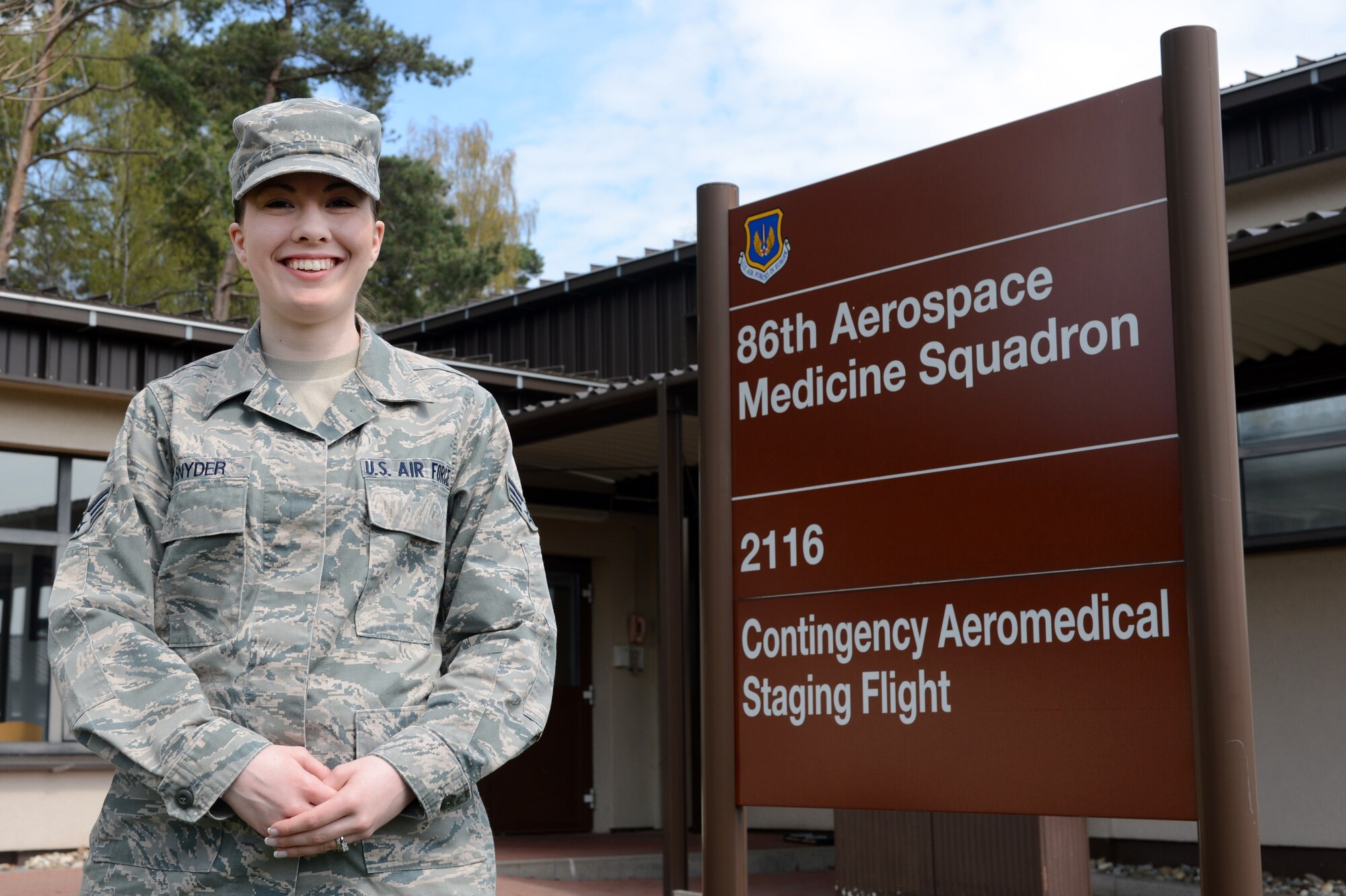 Senior Airman Miranda Snyder, 86th Communications Squadron wing information assurance technician, poses for a photo in front of the Contingency Aeromedical Staging Facility, April 23, 2013, Ramstein Air Base, Germany.  Snyder has been recognized for the U.S. Air Forces in Europe and Air Forces Africa 2013 American Legion Spirit of Service Award, for outstanding volunteer services performed off duty in the local community. (U.S. Air Force photo/Senior Airman Caitlin O’Neil-McKeown)