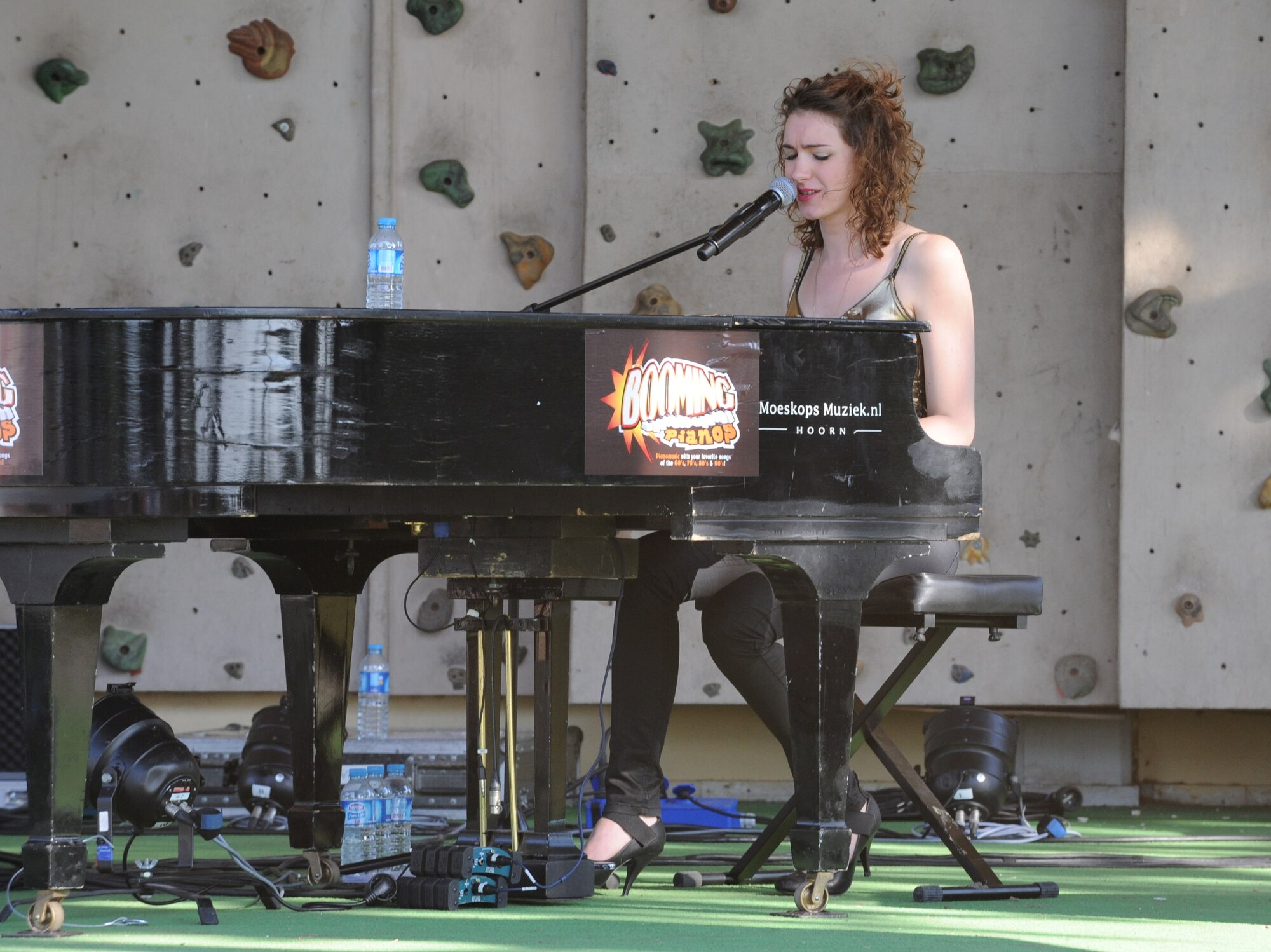 One of three singers and piano players from the music group Booming Pianos performs live at the Dutch Army-hosted Koninginnedag, or Queen’s Day,  celebration held at Arkadas Park April 25, 2013, Incirlik Air Base, Turkey. Koninginnedag is a Dutch national holiday that is observed April 30. The Dutch soldiers are deployed to Incirlik Air Base as part of a NATO-led operation to boost Turkey’s air defense capabilities by providing Patriot missile batteries. (U.S. Air Force photo by 1st Lt. David Liapis/Released)