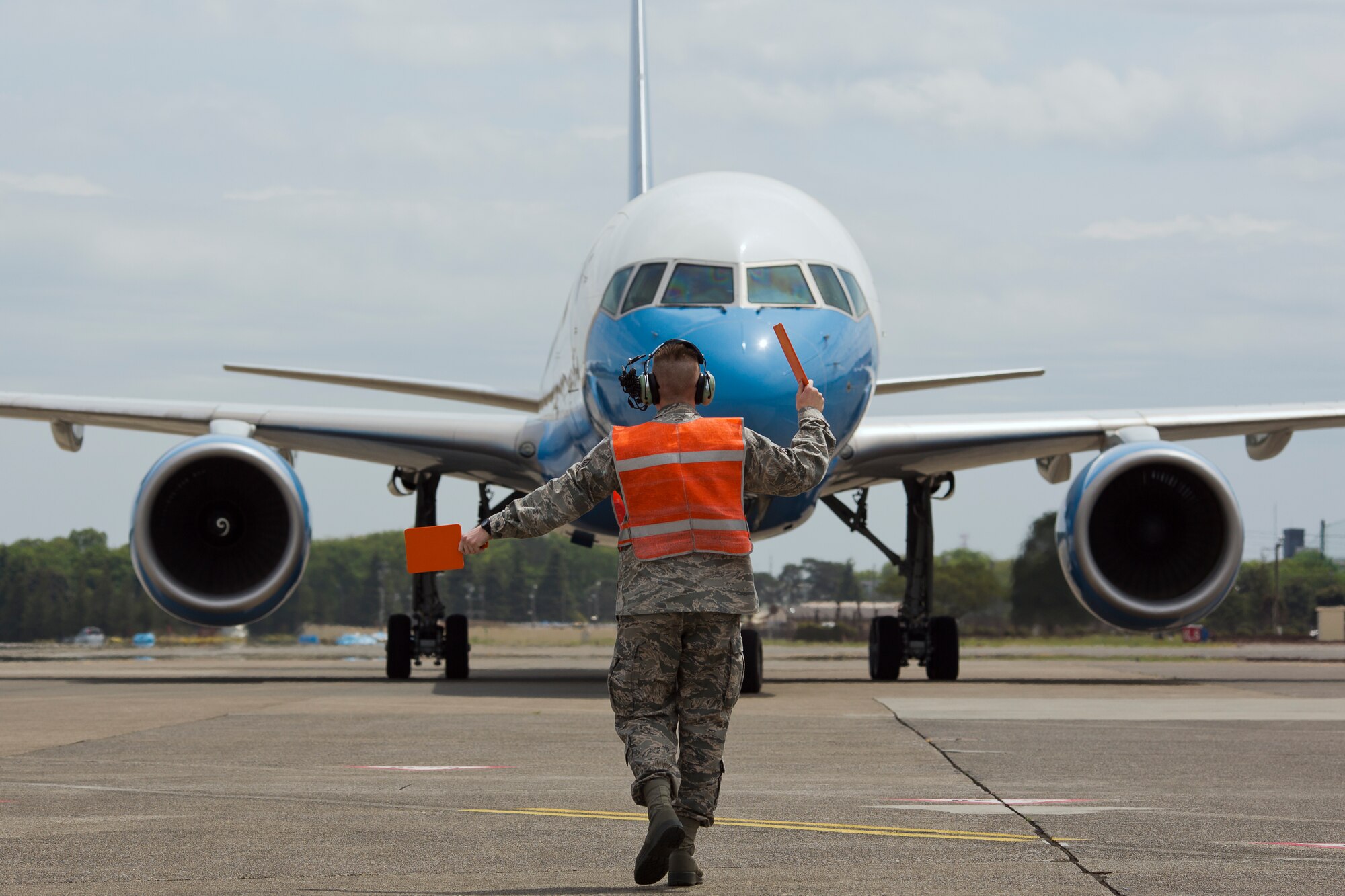 YOKOTA AIR BASE, Japan -- Air Force Senior Airman Max Evans, 374th Maintenance Squadron Transient Alert maintenance journeyman, marshals a C-32 aircraft at Yokota Air Base, Japan, April 25, 2013. (U.S. Air Force photo/Osakabe Yasuo) 