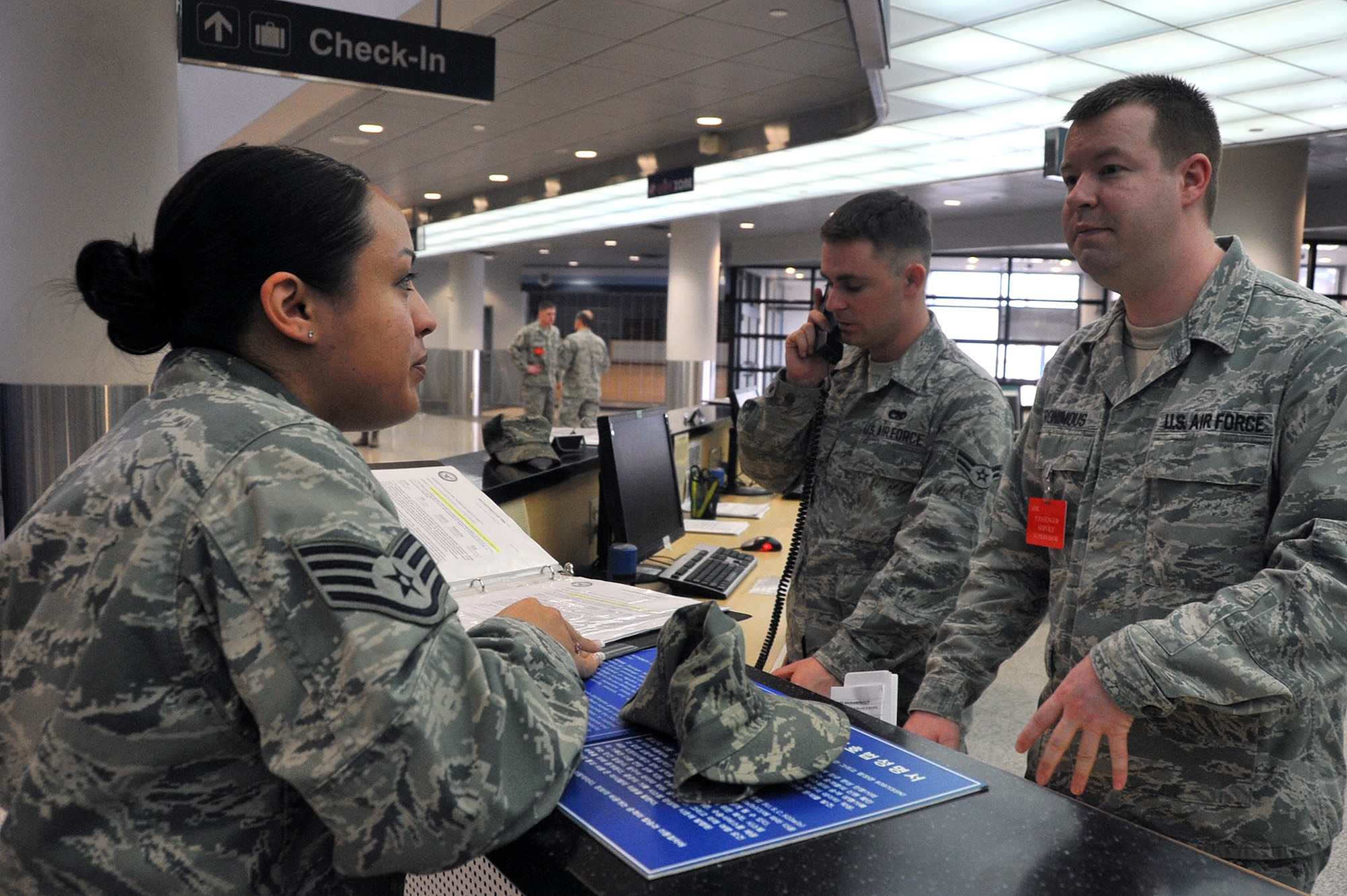 Staff Sgt. Jessicca Montague, 51st Logistics Readiness Squadron distribution vehicle operator, speaks with Staff Sgt. Nathan Ronimous, 731st Air Mobility Squadron passenger service supervisor, about Space-Available travel at the Osan passenger terminal on Osan Air Base, Republic of Korea, April 23, 2013. Space-A is travel authorized by the Department of Defense for passengers to occupy the surplus of seats after all space-required passengers and cargo have been accommodated. (U.S. Air Force photo/Senior Airman Alexis Siekert)