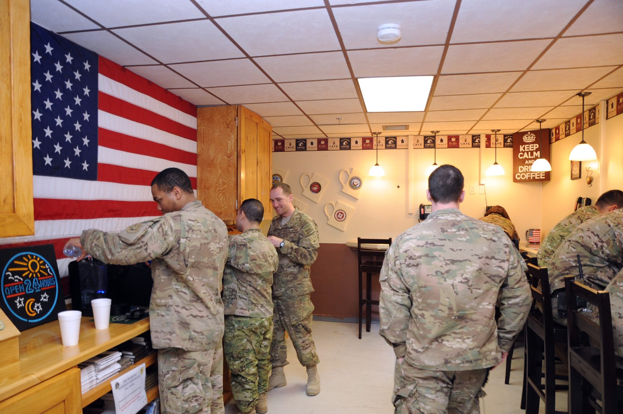 Members of the 455th Expeditionary Medical Group enjoy the new "Holy Joe's" cafe in the Craig Joint Theater Hospital on Bagram Airfield, Afghanistan, April 21, 2013. The cafe was created from a nondescript storeroom through the efforts of the hospital facility manager and the 455th EMDG chaplain team. (U.S. Air Force photo by Staff Sgt. David Dobrydney)