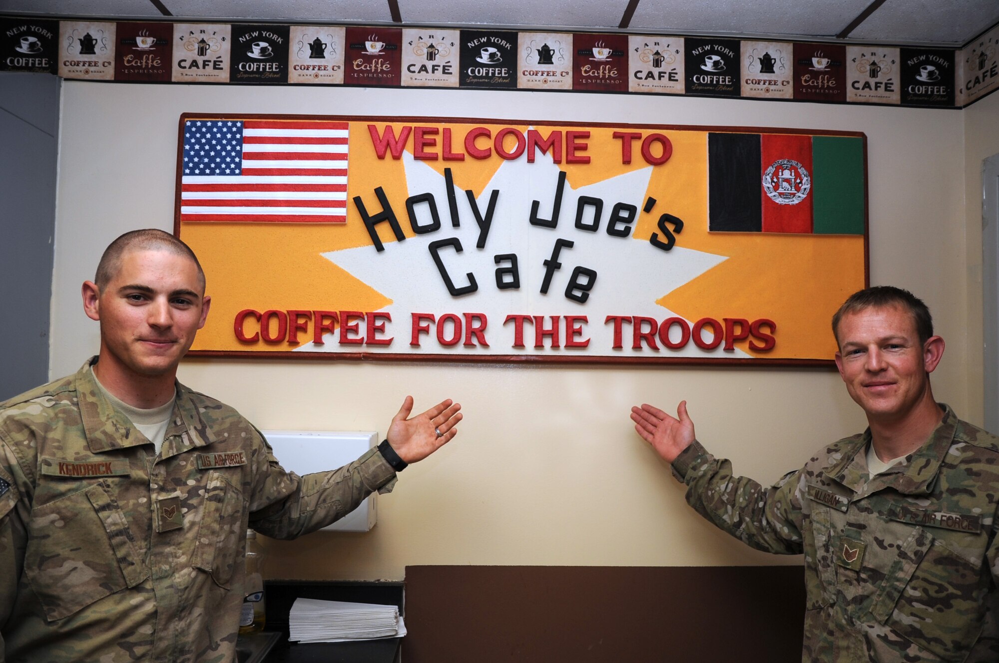 Staff Sgt. Logan Kendrick, 455th Expeditionary Medical Support Squadron facility manager, and Tech. Sgt. Sheldon Milligan, 455th Air Expeditionary Wing chaplain assistant, welcome 455th Medical Group personnel to the newly renovated "Holy Joe's" coffee shop in the Craig Joint Theater Hospital on Bagram Airfield, Afghanistan, April 21, 2013. Holy Joe's was created from a nondescript storeroom in little more than two months for the benefit of the 455th EMDG staff and hospital visitors. (U.S. Air Force photo by Staff Sgt. David Dobrydney)