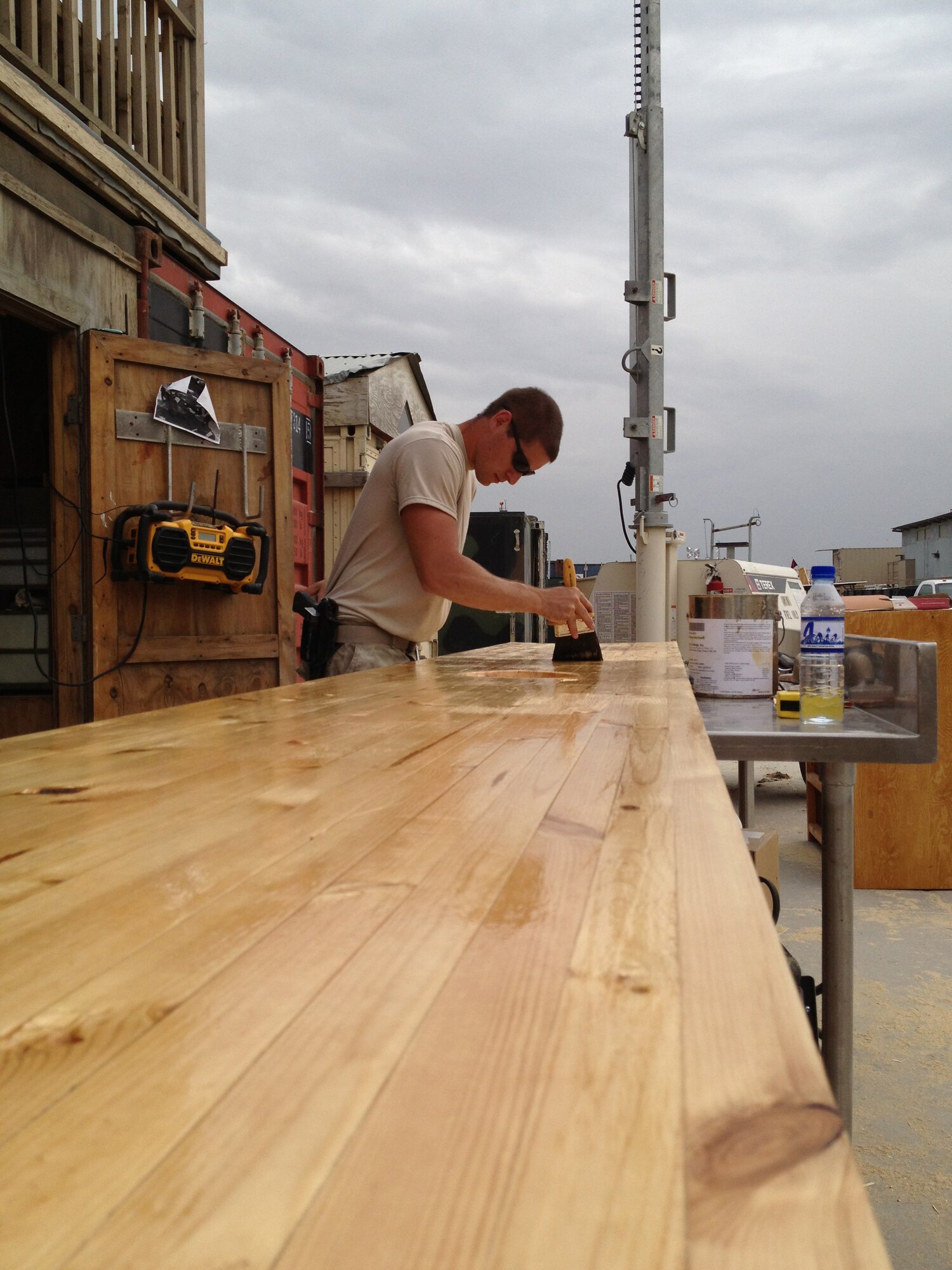 Staff Sgt. Logan Kendrick, 455th Expeditionary Medical Support Squadron facility manager applies a finish to a countertop for the new "Holy Joe's" break room in the Craig Joint Theater Hospital on Bagram Airfield, Afghanistan, April 16, 2013. Kendrick built the countertop from scratch using skills he learned growing up. (U.S. Air Force photo courtesy of Tech. Sgt. Sheldon Milligan)