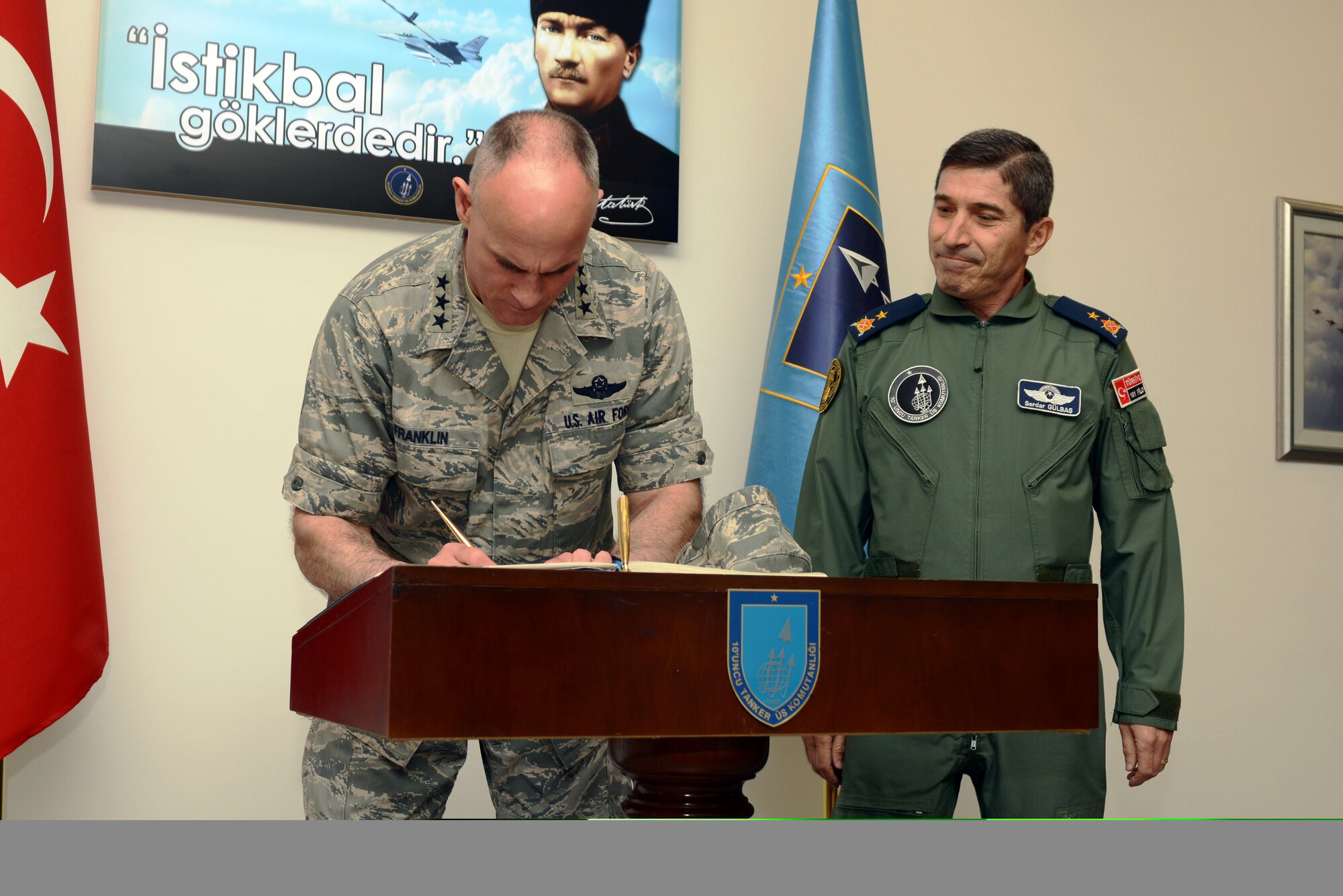 Lt. Gen. Craig A. Franklin, 3rd Air Force commander, signs a guest book during a visit with Turkish Air Force Brig. Gen. Serdar Gulbas, commander of the 10th Tanker Command April 18, 2013, at Incirlik Air Base, Turkey. During his visit, Franklin praised Gulbas for his contributions toward the strong partnership between the 39th Air Base Wing and 10th Tanker Command. (U.S. Air Force photo by Tech. Sgt. Dallas Edwards/Released)