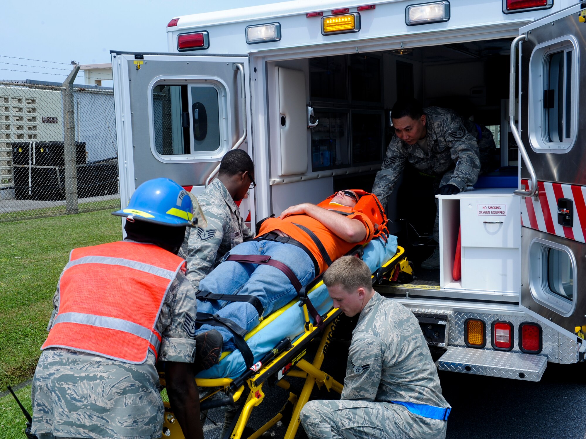 A U.S. Air Force medical response team put a simulated patient into an ambulance for transportation to the hospital during an emergency management exercise on Kadena Air Base, Japan, April 25, 2013. EMEs are designed to test, train and evaluate the base's ability to respond to crisis situations in the region.  (U.S. Air Force photo by Airman 1st Class Justin Veazie/Released)