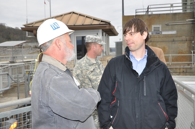 Jim Niznik (Left), civil engineer and Tennessee Valley Authority navigation specialist, answers a question from Ben Portis, TVA, during an April 3, 2013 visit by Congressional staff members to Chickamauga Lock in Chattanooga, Tenn. Niznik represents TVA on the Corps of Engineers and TVA Project Delivery Teams for both the old and new Chickamauga navigation lock projects at Chattanooga, and the Kentucky Lock Addition Project in western Kentucky. Standing behind them is Lt. Col. James A. DeLapp, commander, U.S Army Corps of Engineers Nashville District.