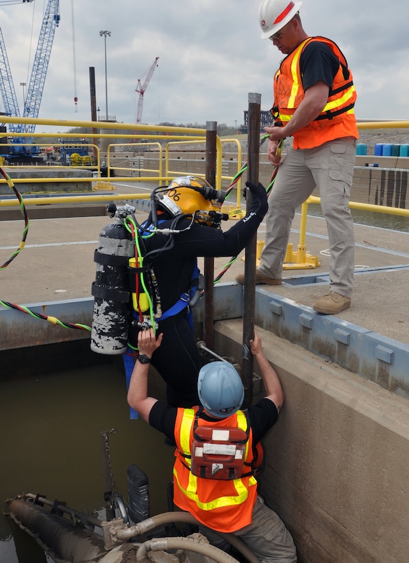 Teamwork is key. 1st Sgt. Milton Prather (above right) and Pfc. Jace Dilmore (below right) help Sgt. Patrick Morales keep his umbilical lines from tangling as he descends to the culvert.