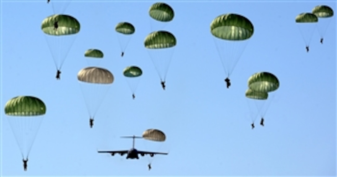Paratroopers of the U.S. Army’s 4th Brigade Combat Team (Airborne) 25th Infantry Division parachute over the Malemute Drop Zone at Joint Base Elmendorf-Richardson, Alaska, on April 17, 2013.  Nearly 60 soldiers jumped from the U.S. Air Force C-17 Globemaster III.  