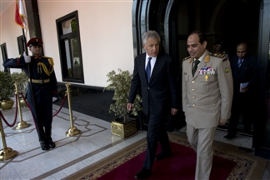Secretary of Defense Chuck Hagel, left, walks with Egyptian Minister of Defense Abdel Fatah Saeed Al Sisy in Cairo, Egypt, on April 24, 2013.  Egypt is Hagel's fourth stop on a six-day trip to the Middle East to meet with defense counterparts.  