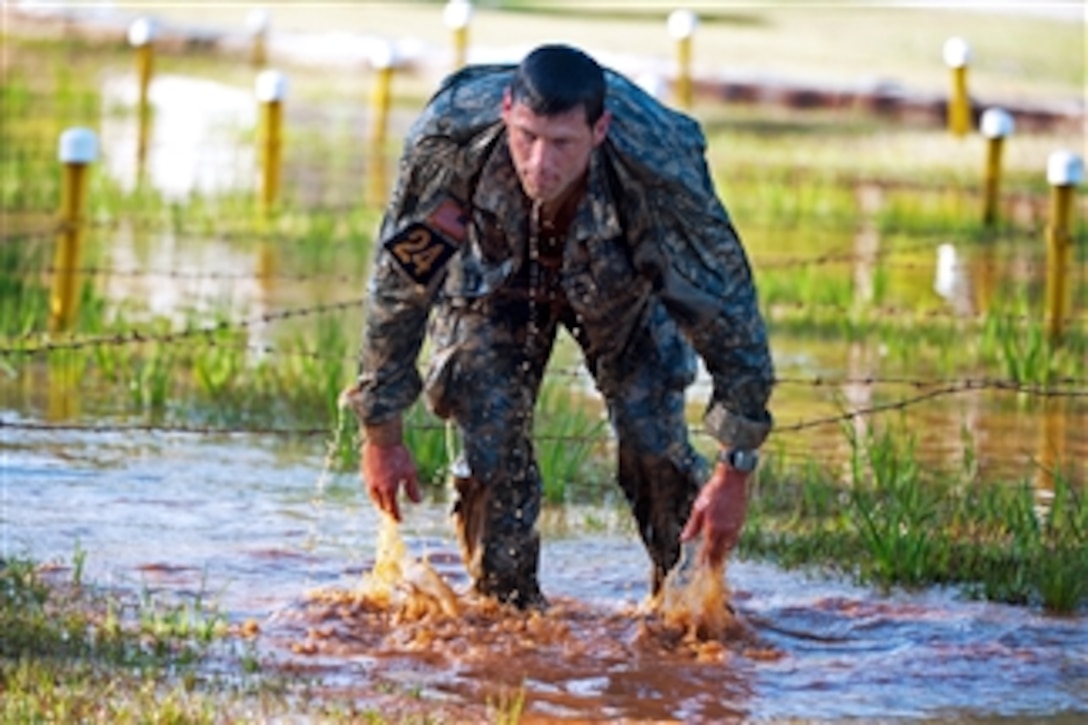 U.S. Army Master Sgt. Christopher Nelms emerges from the “Worm Pit” on the Malvesti Obstacle Course during the Best Ranger Competition at Fort Benning, Ga., on April 13, 2013.  Nelms is attached to the United States Army Special Operations Command, Headquarters, Headquarters Company and is competing with teammate Maj. Casey Mills in the 2013 competition.  