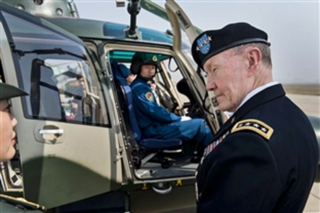 U.S. Army Gen. Martin E. Dempsey, right, chairman of the Joint Chiefs of Staff, receives a briefing on Chinese helicopter aviation at a military post near Beijing, April  24, 2013.  