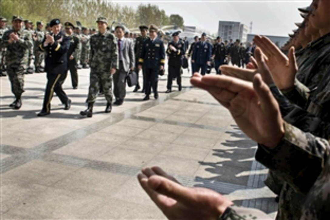 U.S. Army Gen. Martin E. Dempsey, left, chairman of the Joint Chiefs of Staff, arrives at at the Chinese Army Aviation Academy near Beijing, April 24, 2013.  