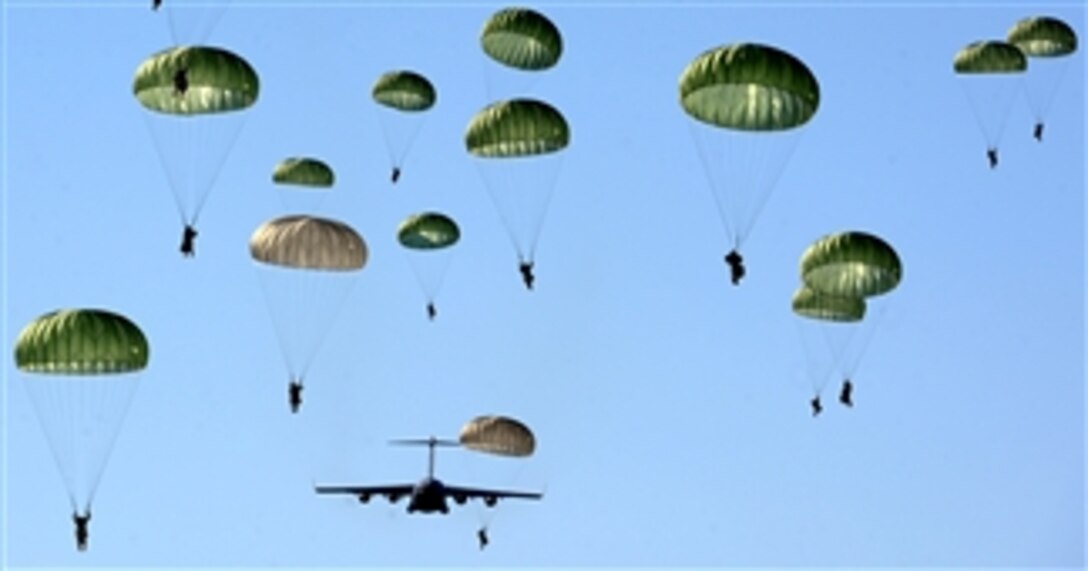 Paratroopers of the U.S. Army’s 4th Brigade Combat Team (Airborne) 25th Infantry Division parachute over the Malemute Drop Zone at Joint Base Elmendorf-Richardson, Alaska, on April 17, 2013.  Nearly 60 soldiers jumped from the U.S. Air Force C-17 Globemaster III.  