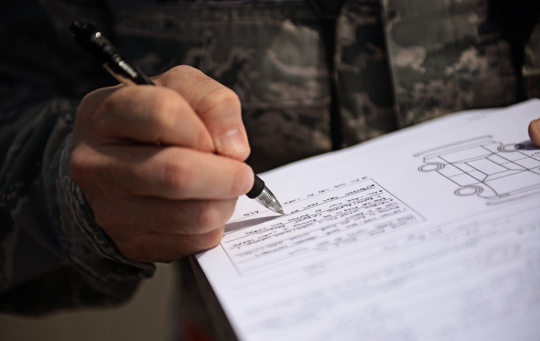 Capt. Michael Garcia, 375th Air Mobility Wing judge advocate, fills out a damage to personal property claim form for a government employee on Scott Air Force Base April 22, 2013, following severe weather which caused flooding in many areas on base. Due to the massive flooding on base the legal office was able to have the area declared as an "unusual event" allowing people to file claims with the Air Force Claims Service Center.(U.S. Air Force photo/ Staff Sgt. Ryan Crane)