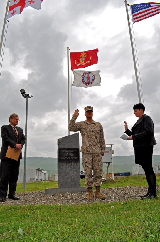 Corporal Erick R. Salinas repeats the oath as he executes his naturalization ceremony at the U.S. Embassy in Tbilisi, Georgia. Salinas is an infantryman assigned the Georgia Training Team, currently working at Vaziani Training Area training with Georgian soldiers. Ambassador Richard Norland presided over the naturalization ceremony. 