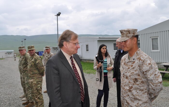 Ambassador Richard Norland chats with Corporal Erick R. Salinas after presiding over Salinas' naturalization ceremony at the U.S. Embassy in Tbilisi, Georgia.  Salinas is an infantryman assigned the Georgia Training Team, currently working at Vaziani Training Area training with Georgian soldiers. 

