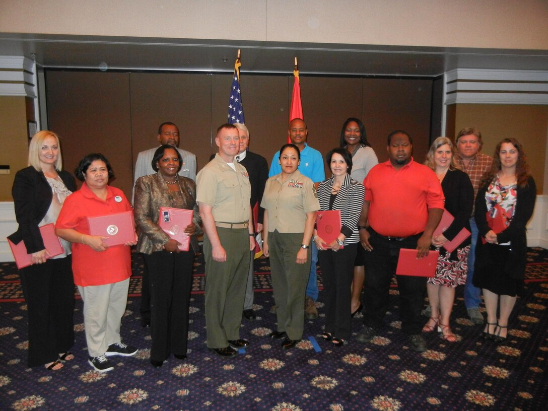 Quantico honors civilians of the quarter and civilian lengths of service. From left are Rebecca Childress, junior civilian of the quarter; Delilah Amen; Bobby Brown; Martha Harris; Col. David Maxwell, base commander; Ken Pittman, senior civilian of the quarter; Sgt. Maj. Laura Brown, base sergeant major; Byron Flakes; Fatima McCoy; Leslie Nicole Perry; Jonathan McKinney; Betty Mayfield; Ronald Moyer; and Sherry Schaarshmidt. 