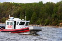 Members of the Amphibious Operations, part of Marine Corps Systems Command’s Reconnaissance and Amphibious Raids, drive an open-water safety craft back to the dock after putting Marines ashore April 22.  RAR teamed up with the base’s Natural Resources and Environmental Affairs to transport Marines by boat to various locations along the Potomac River shoreline to collect debris as part of the 2013 Marine Corps Base Quantico Spring Cleanup.