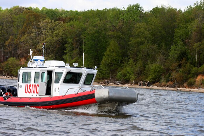 Members of the Amphibious Operations, part of Marine Corps Systems Command’s Reconnaissance and Amphibious Raids, drive an open-water safety craft back to the dock after putting Marines ashore April 22.  RAR teamed up with the base’s Natural Resources and Environmental Affairs to transport Marines by boat to various locations along the Potomac River shoreline to collect debris as part of the 2013 Marine Corps Base Quantico Spring Cleanup.