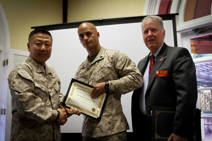 Brig. Gen. Daniel D. Yoo, commanding general, Marine Corps Recruit Depot San Diego and Western Recruiting Region and Jim Guerin, president, Marine Corps Recruit Depot San Diego Historical Society, present the Drill Instructor of the Year Award for 2nd Recruit Training Battalion, to Staff Sgt. Joshua P. LeBlanc, April 23 for his work with Co. G, 2nd RTBn, aboard Marine Corps Recruit Depot San Diego. The ceremony recognized drill instructors from MCRD San Diego and included, Staff Sgt. Neil Gregory Seip, who received DI of the Year for his work with 3rd Recruit Training Battalion,  Staff Sgt. Zachary D. Curran, who was awarded DI of the Year for Support Battalion, and Gunnery Sgt. Kenneth Williamson, who received the DI of the Year (for the entire Marine Corps) for his work with 1st RTBn. 