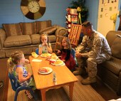 Master Sgt. Shawn A. Martin, an engineering equipment chief with Combat Logistics Battalion 22, 2nd Marine Logistics Group, shares lunch with his daughters during the take your child to work holiday aboard Camp Lejeune, N.C., April 25, 2013. Lunch was provided to servicemembers and their children by family readiness officer Darlene Kern. (U.S. Marine Corps photo by Lance Cpl. Shawn Valosin)