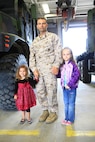 Master Sgt. Shawn A. Martin, an engineering equipment chief with Combat Logistics Battalion 22, 2nd Marine Logistics Group, poses for a photo with his daughters during the Take your child to work holiday aboard Camp Lejeune, N.C., April 25, 2013. Martin showed his daughters where he works and the vehicles they use. (U.S. Marine Corps photo by Lance Cpl. Shawn Valosin)