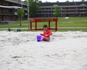 The daughter of a Combat Logistics Battalion 22, 2nd Marine Logistics Group servicemember plays in the sand aboard Camp Lejeune, N.C., April 25, 2013, during the take your child to work holiday. This was the second year that CLB-2 participated in the holiday. (U.S. Marine Corps photo by Lance Cpl. Shawn Valosin)