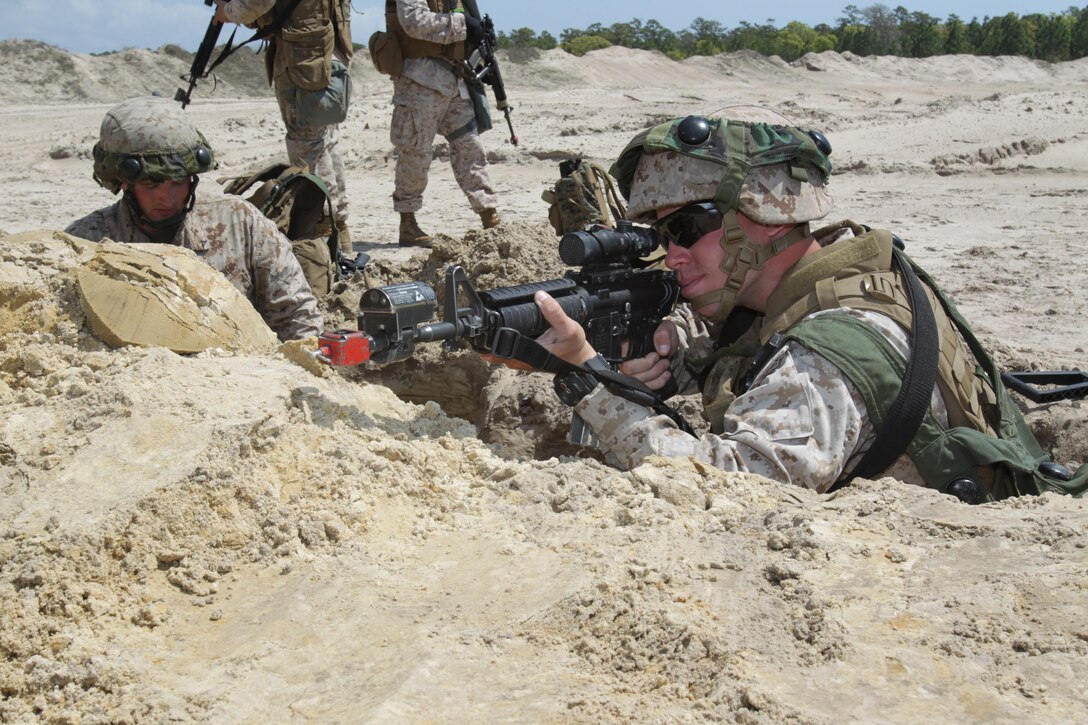 Lance Cpl. Tyler Reitzel, 3rd platoon, 2nd squad, provides cover as his buddy finishes their fighting hole during a field training exercise aboard Marine Corps Base Camp Lejeune, April 17. Marines With Marine Wing Support Squadron 272 took to the field to hone the skills learned during Marine Combat Training and to practice airbase ground defense, one of the squadron’s mission essential tasks. 
