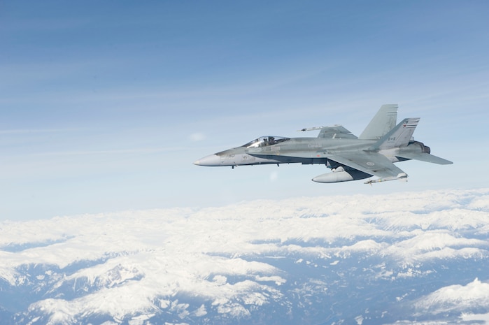 Seen from the window of a Canadian Forces CC-150 Polaris tanker, a CF-18 Hornet fighter jet prepares to refuel in the air over Vancouver during Operation PODIUM.

Operation PODIUM is the Canadian Forces (CF) contribution to the overall security of the Vancouver 2010 Olympic and Paralympic Winter Games in support of the Royal Canadian Mounted Police (RCMP)-led Integrated Security Unit. The Air Force’s contribution is two-fold: The Air Component Command of Joint Task Force Games, which provides airlift, medical evacuation and area surveillance for the RCMP; and NORAD, which will ensure airspace security. 

During the Vancouver 2010 Olympic and Paralympic Winter Games, from February 12 to March 21, 2010, security and public safety agencies from all levels of government are working together to provide a safe and secure environment while the world celebrates winter sporting excellence.

