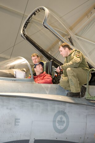 The Honourable Peter MacKay, Minister of National Defence looks up from the cockpit of a CF-18 Hornet while Captain Mark Remington (left) and Captain Mark Hickey (right) brief him on the aircraft during a visit Op PODIUM.

Operation PODIUM is the Canadian Forces (CF) contribution to the overall security of the Vancouver 2010 Olympic and Paralympic Winter Games in support of the Royal Canadian Mounted Police (RCMP). The Air Force’s contribution is two-fold: The Air Component Command of Joint Task Force Games, which provides airlift, medical evacuation and area surveillance for the RCMP, and NORAD, which will ensure airspace security. 

During the Vancouver 2010 Olympic and Paralympic Winter Games, from February 12 to March 21, 2010, security and public safety agencies from all levels of government are working together to provide a safe and secure environment while the world celebrates winter sporting excellence.


