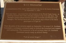 PETERSON AIR FORCE BASE, Colo. - The plaque of the new 9-11 memorial describes the design of the memorial and its three parts, the steel beam representing the World Trade Center, the five-sided planter representing the Pentagon, and Pennsylvania soil representing crash site of Flight 93. The memorial will be commemorated in a ceremony at 1 p.m. May 18. 

(U.S. Air Force photo by Staff Sgt. Thomas J. Doscher) 

