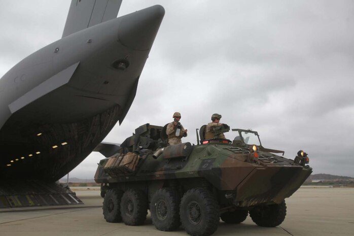 A light armored vehicle carrying Marines serving with 1st Light Armored Reconnaissance Battalion unloaded out of a C-17 Globemaster cargo plane during a strategic mobility exercise here, April 24, 2013. The C-17's long-range capability gives 1st LAR the ability to deploy worldwide at a moment's notice. The Marines learned the basics of loading and unloading from aircraft to prepare for upcoming deployments.