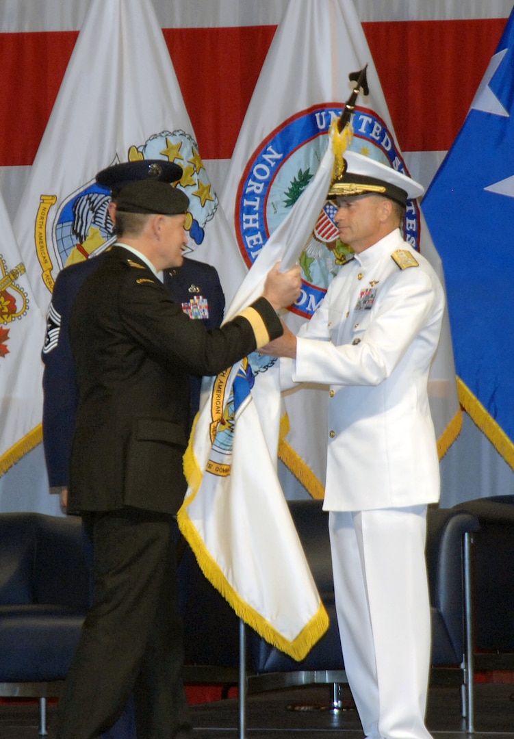 PETERSON AIR FORCE BASE, Colo. - Canadian Gen. Walt Natynczyk, Chief of the Canadian Defence Staff, presents the North American Aerospace Defense flag to Navy Adm. James Winnefeld, NORAD and U.S. Northern Command commander, during the commands' change of command ceremony at Peterson Air Force Base May 19. 

(U.S. Air Force photo by Staff Sgt. Thomas J. Doscher) 

