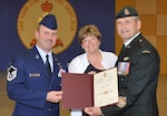 FORT SAINT-JEAN, Canada - Air Force Master Sgt. Jerry Simer and his wife, DeeAnn, pose for a photo with Canadian Forces Chief Warrant Officer Greg Lacroix, at Simer's graduation from the Canadian Forces Advanced Leadership Qualification Course at the Non-Commissioned Member Professional Development Centre at Fort Saint-Jean, Quebec, June 18. Simer is the first U.S. servicemember to graduate from the course. 

(Courtesy photo) 

