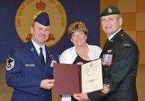 FORT SAINT-JEAN, Canada - Air Force Master Sgt. Jerry Simer and his wife, DeeAnn, pose for a photo with Canadian Forces Chief Warrant Officer Greg Lacroix, at Simer's graduation from the Canadian Forces Advanced Leadership Qualification Course at the Non-Commissioned Member Professional Development Centre at Fort Saint-Jean, Quebec, June 18. Simer is the first U.S. servicemember to graduate from the course. 

(Courtesy photo) 

